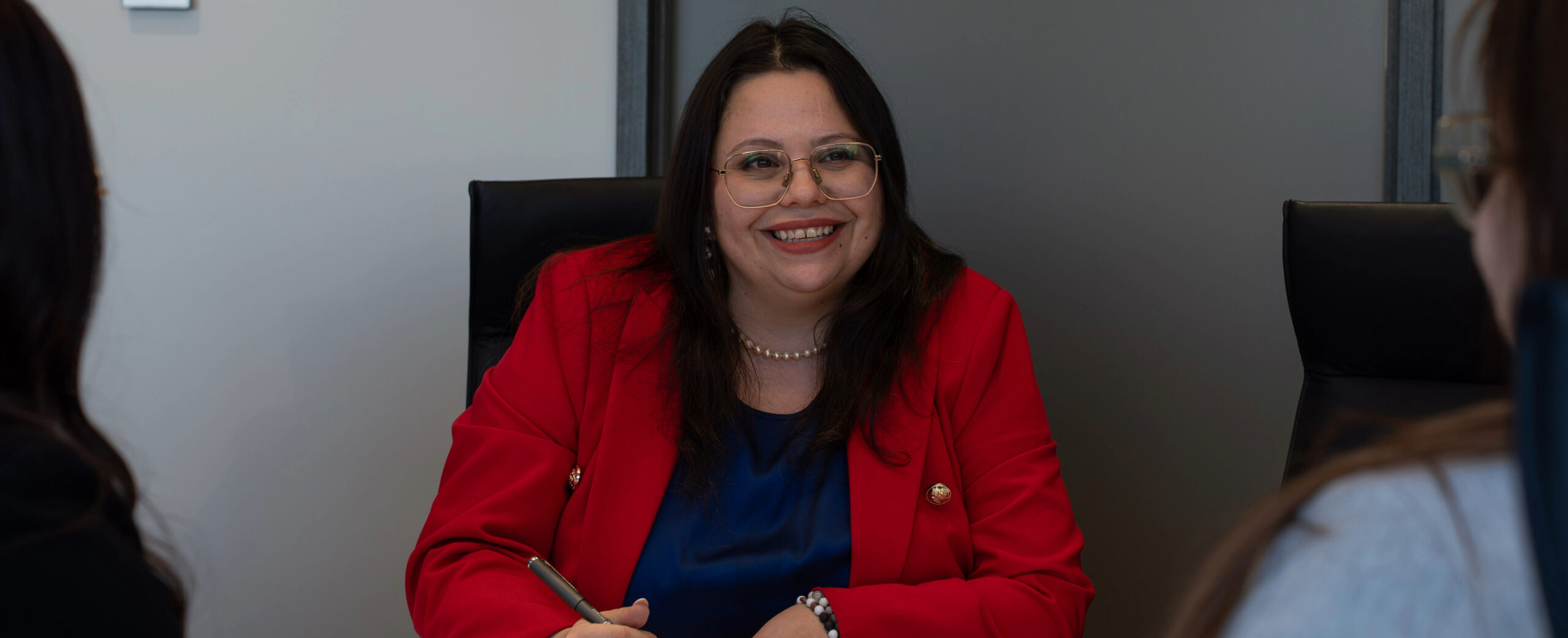 Lawyers meeting with clients in a boardroom.